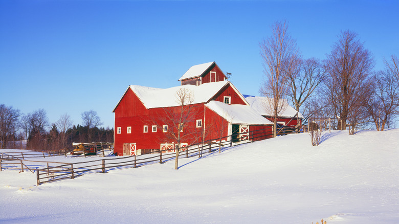 red barn in snow covered field