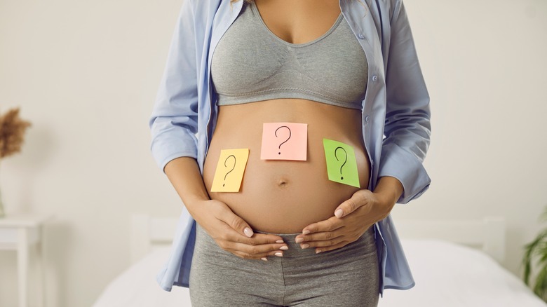 Pregnant belly with question marks
