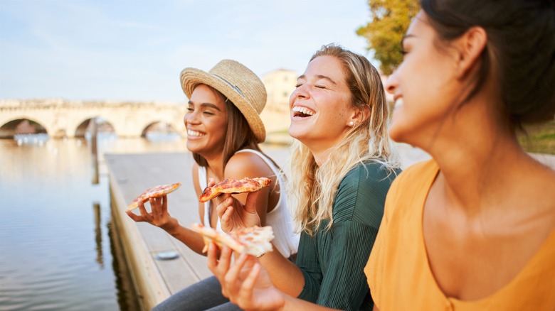 Travelers eating pizza in Venice