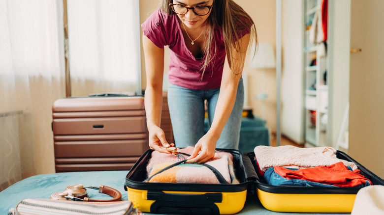 Woman packing luggage 