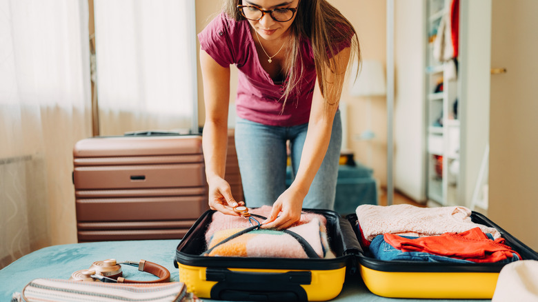 Woman packing luggage