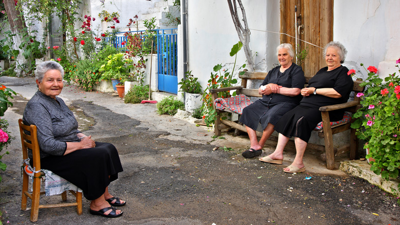 Three women sitting outside