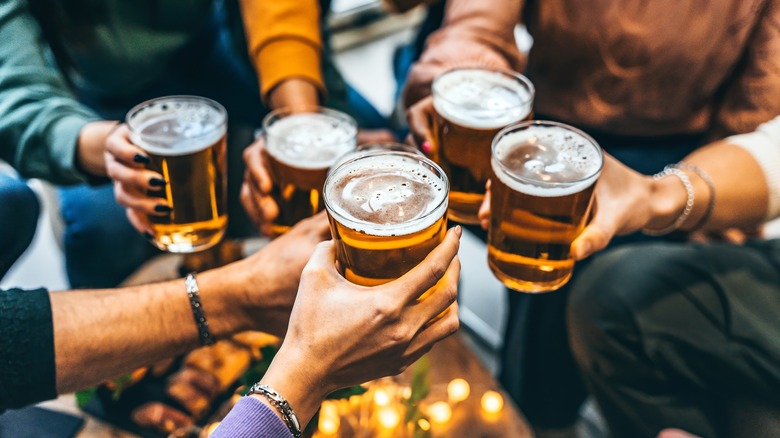 Friends toasting with beer mugs