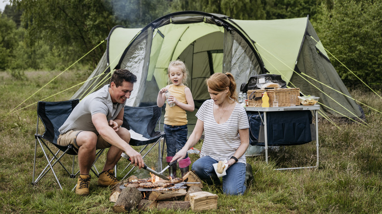 Family cooking by their tent