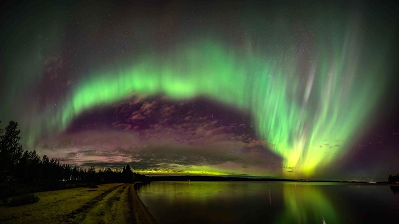 Aurora borealis over the surface of a lake