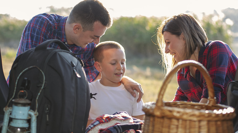 smiling family with picnic items