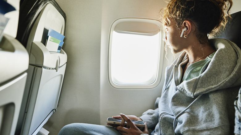 Traveler looking out plane window