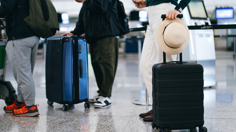 Passengers standing with suitcases