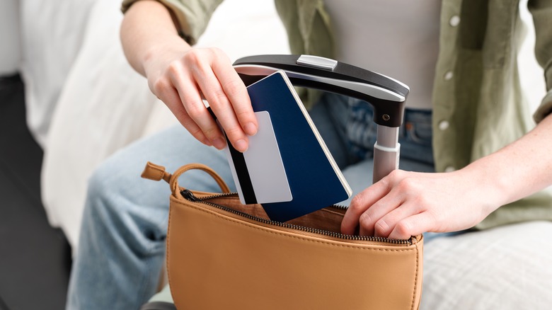 traveler holding passport and card