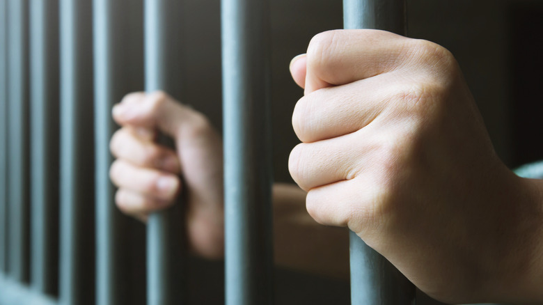 Hands on jail bars