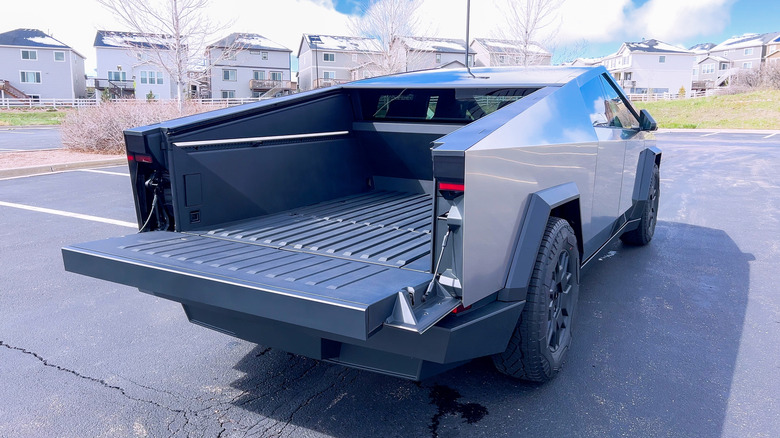 A Tesla Cybertruck parked on a suburban lot with open bed