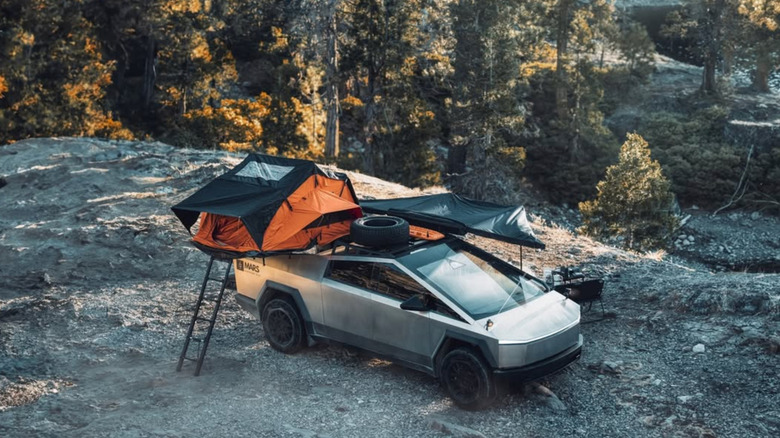 Tesla Cybertruck outfitted with a tent on campsite