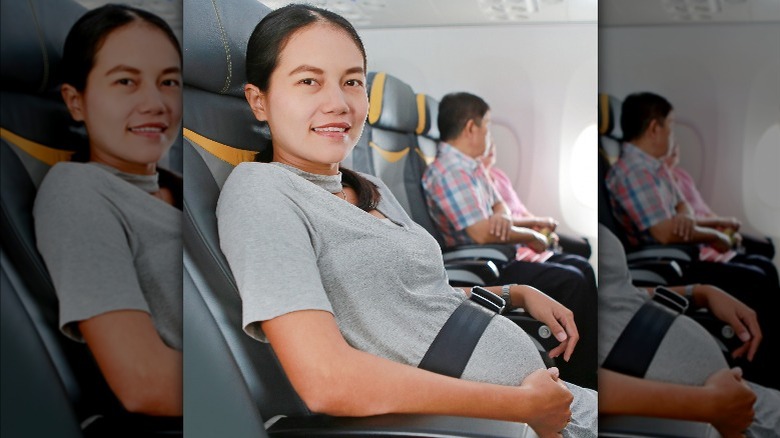 Pregnant person sitting in plane 