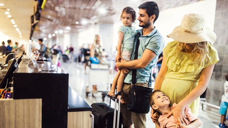 Family checking bags at airport