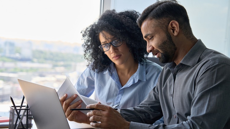 Man and woman looking over paperwork