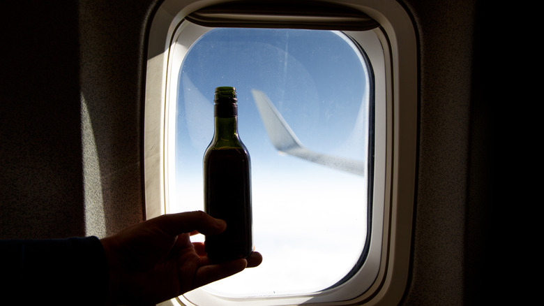 Mini bottle and airplane window