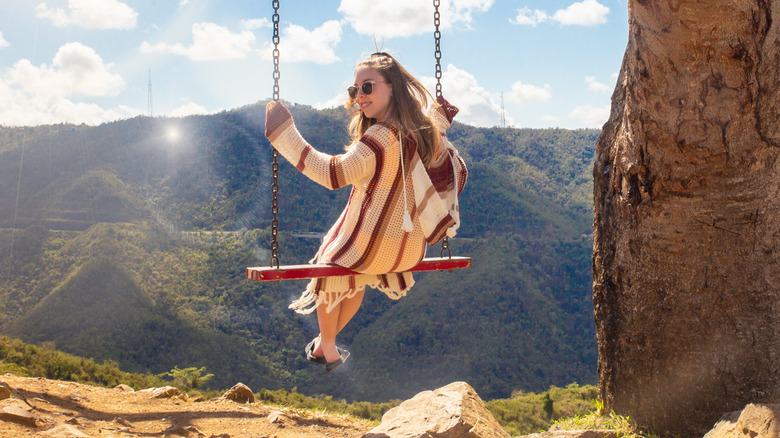 Woman swinging near a valley