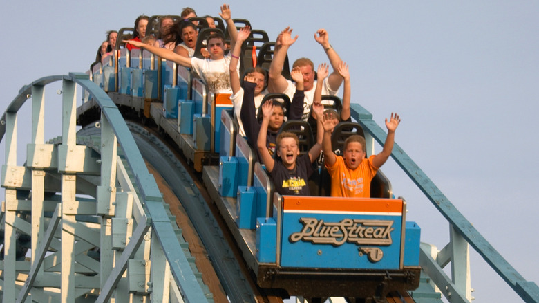 Families riding roller coaster 