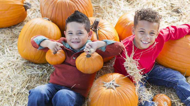 Children holding pumpkins
