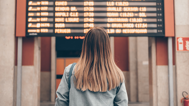 Traveler looking at train schedule