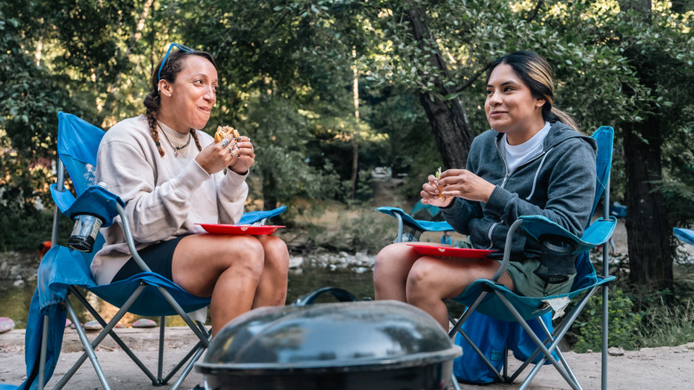Two friends eating outdoors