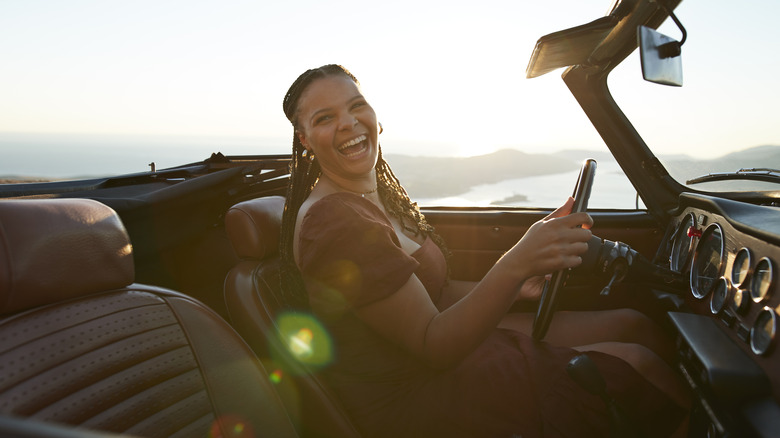 Young traveler driving a convertible