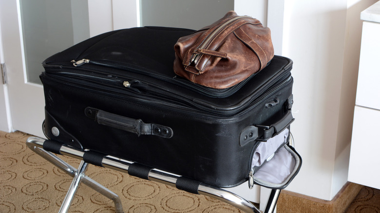 suitcase on hotel luggage rack