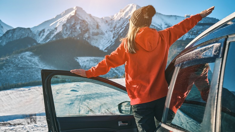 woman outside of car in mountains