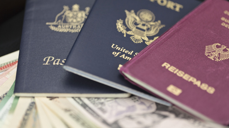 Multiple passports sitting on currency