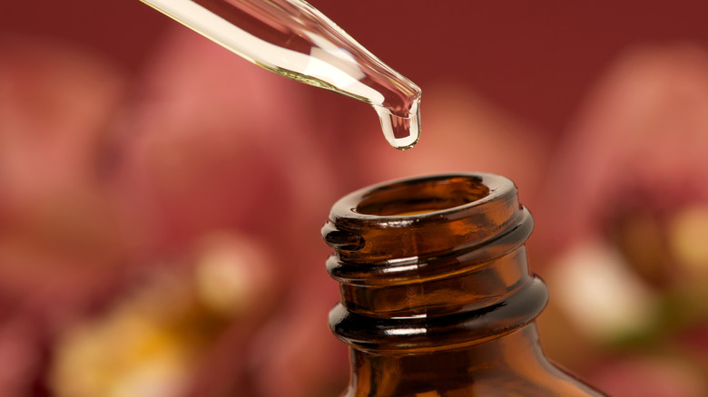 Woman with essential oil tincture