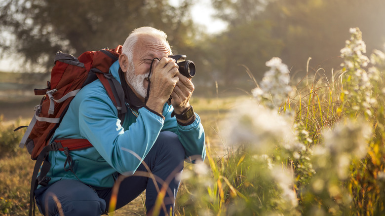 older man using camera outdoors
