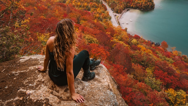 woman on rock vermont autumn