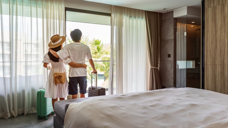 Couple with luggage in room