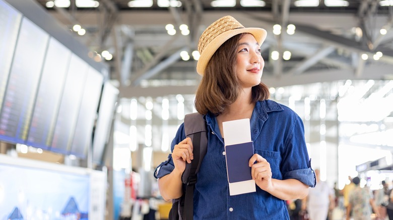 Traveler holding passport and boarding pass