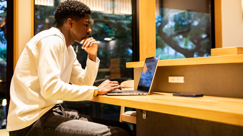 Young traveler using laptop