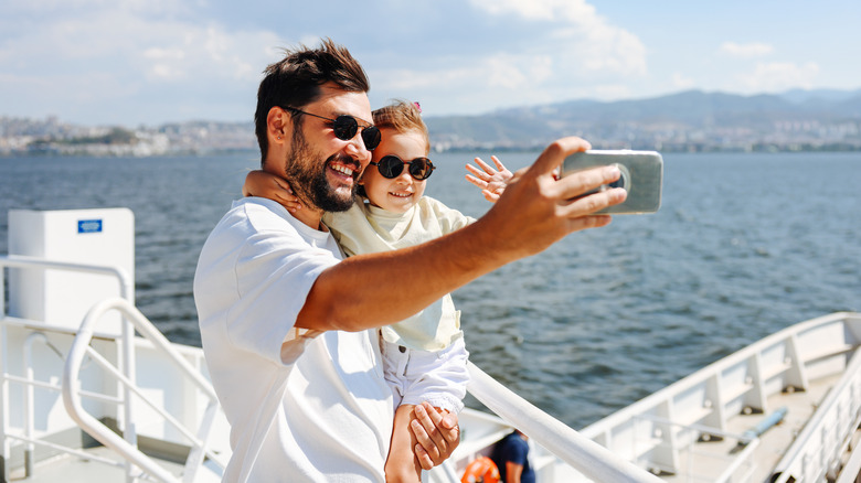 Parent and child taking selfie on cruise