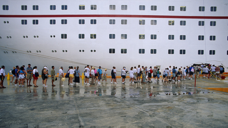 Passengers board cruise ship