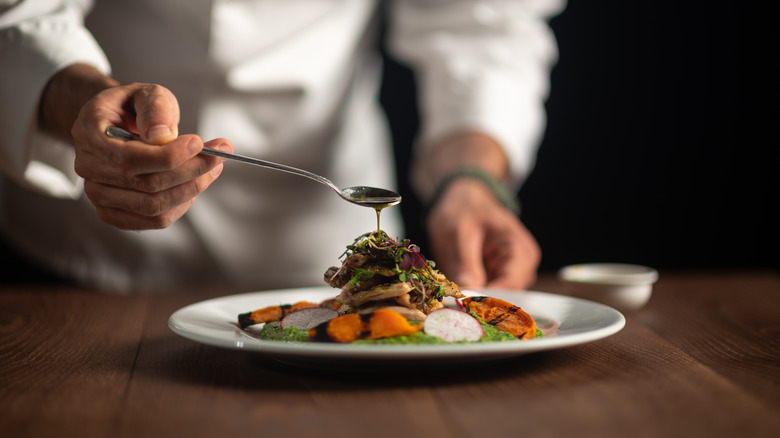 Chef putting sauce on dish