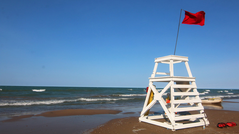 Beach with stand and red flag