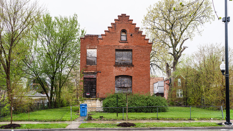 Abandoned brick building in yard