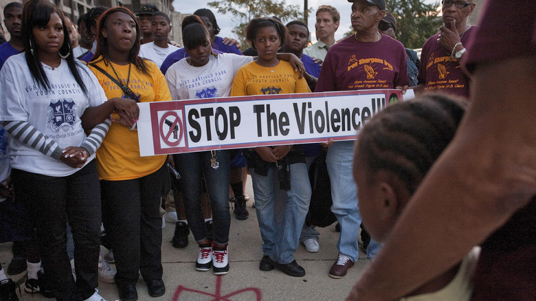 Marchers holding anti-violence sign
