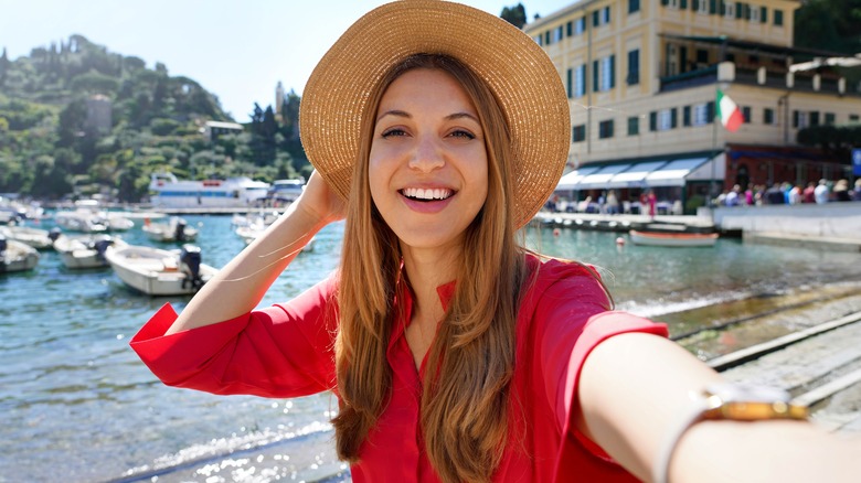 woman taking selfie near marina