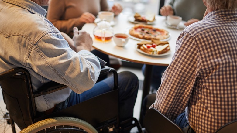 Man in wheelchair at restaurant