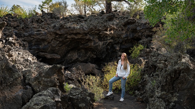 Hiker next to frozen lava flows