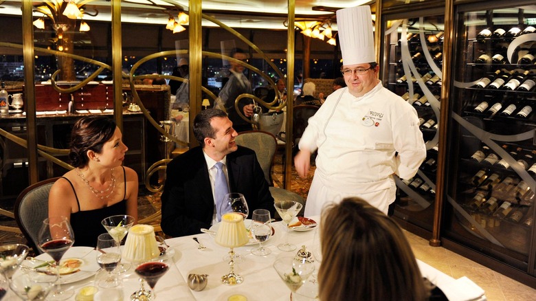 Adults speak to head chef at Remy