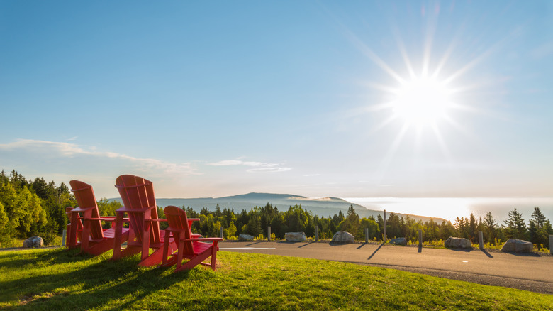 Red chairs overlooking Fundy Bay