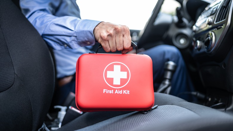 Driver holding first aid kit