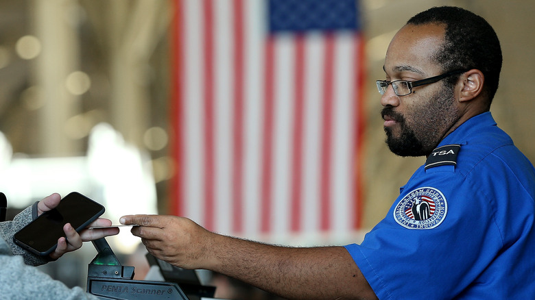 TSA agent returning ID card