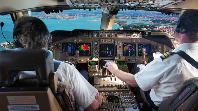 Pilots in plane cockpit