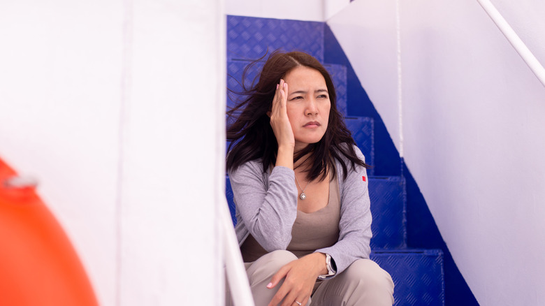 Woman feeling unwell aboard a ship